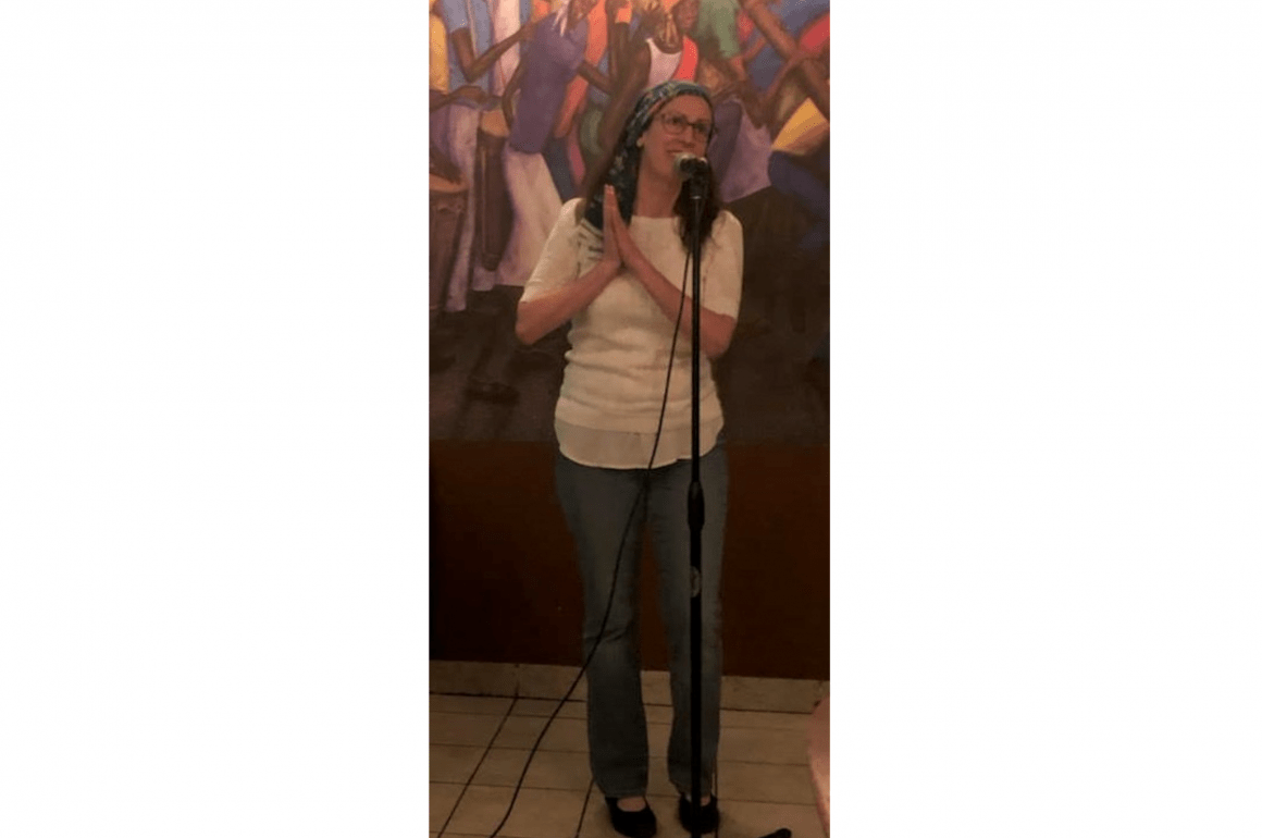 Liza Achilles performing at Poetry at the Port as a featured poet