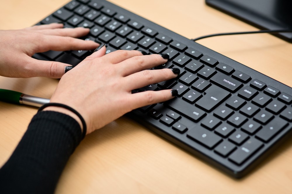 black fingernail painted fingers on keyboard goth