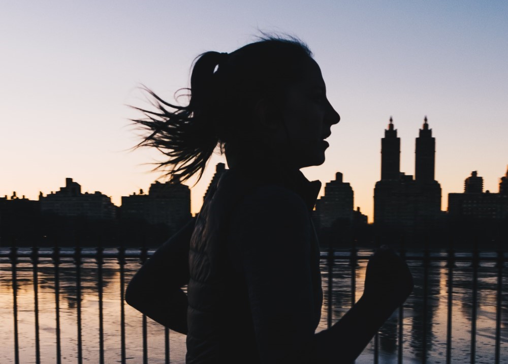woman running with skyline in background