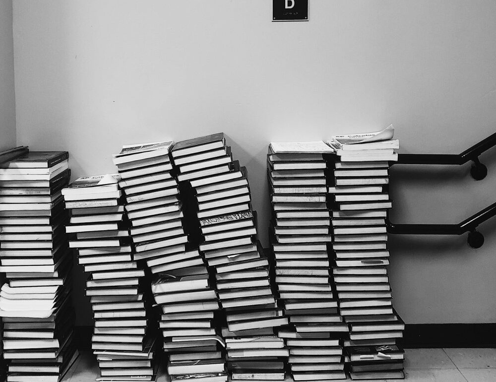 stacks of books in a stairwell